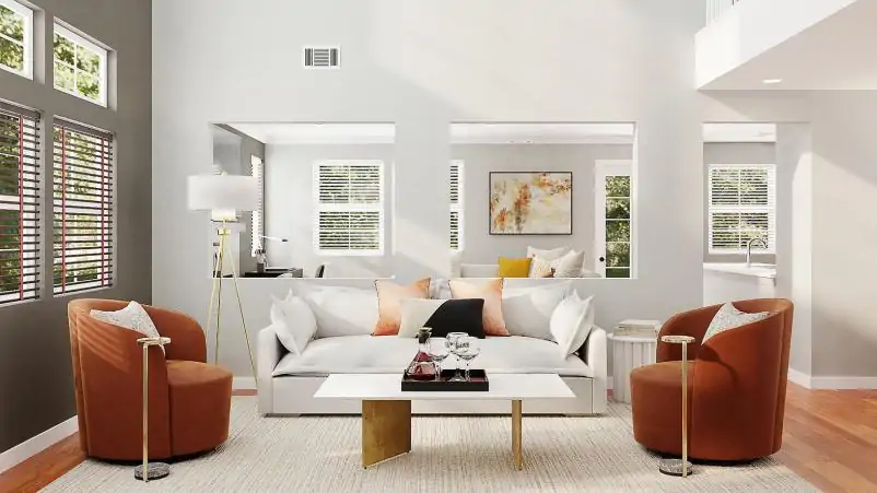 Un canapé au ton clair, accompagné de 2 fauteuils ton terracotta. Au sol est posé un tapis blanc cassé et une table basse au design sobre et moderne.