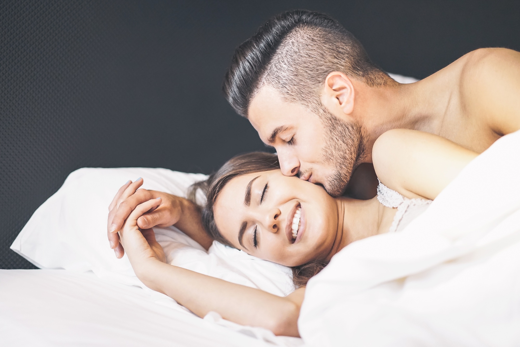Happy couple waking up in the morning at home